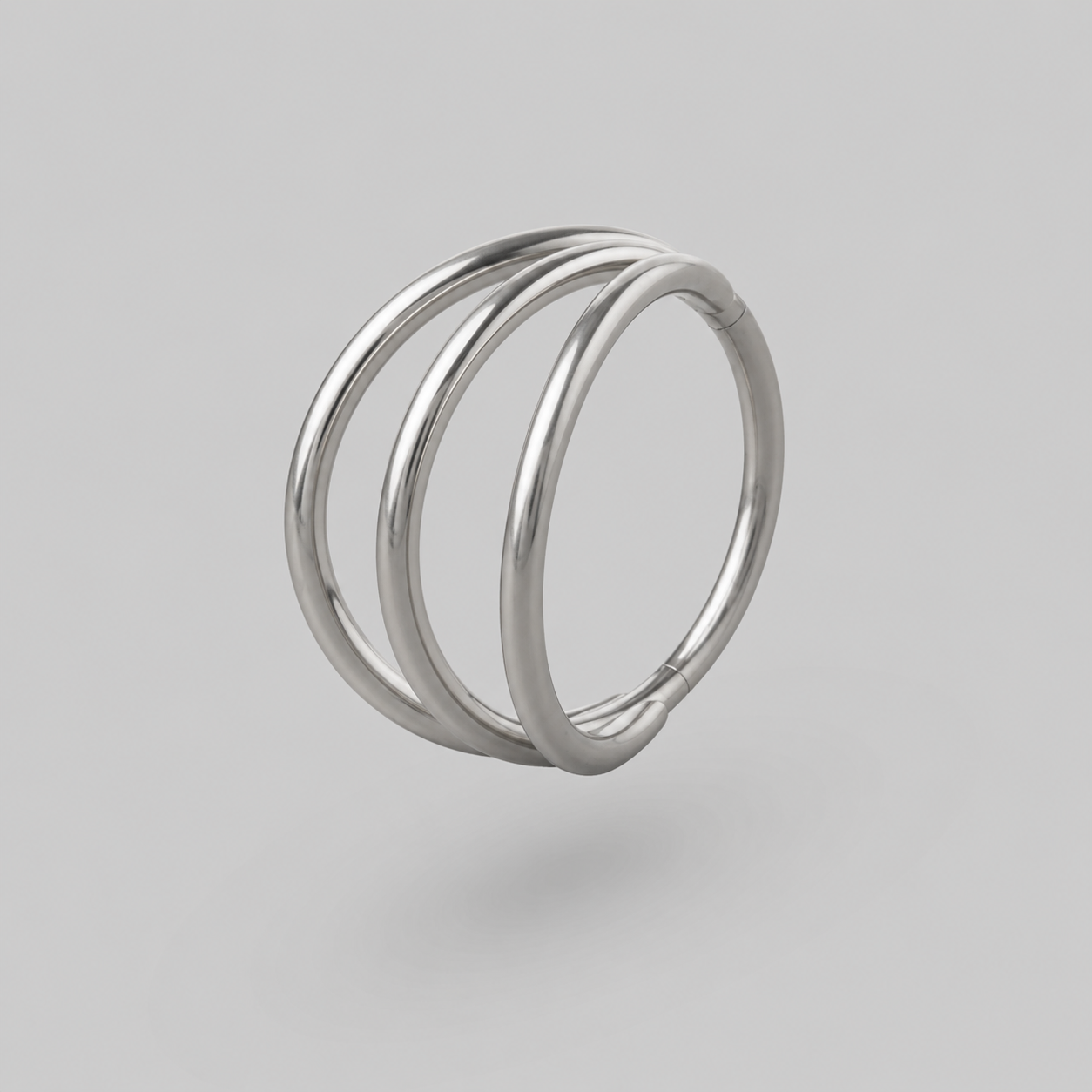 Silver ring with three interlocking loops on a gray background